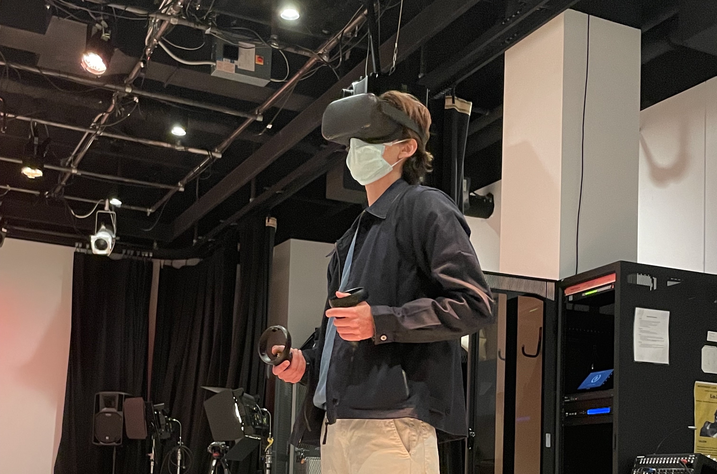 A photo of Eli Duncan standing in the Movement Lab using a VR headset