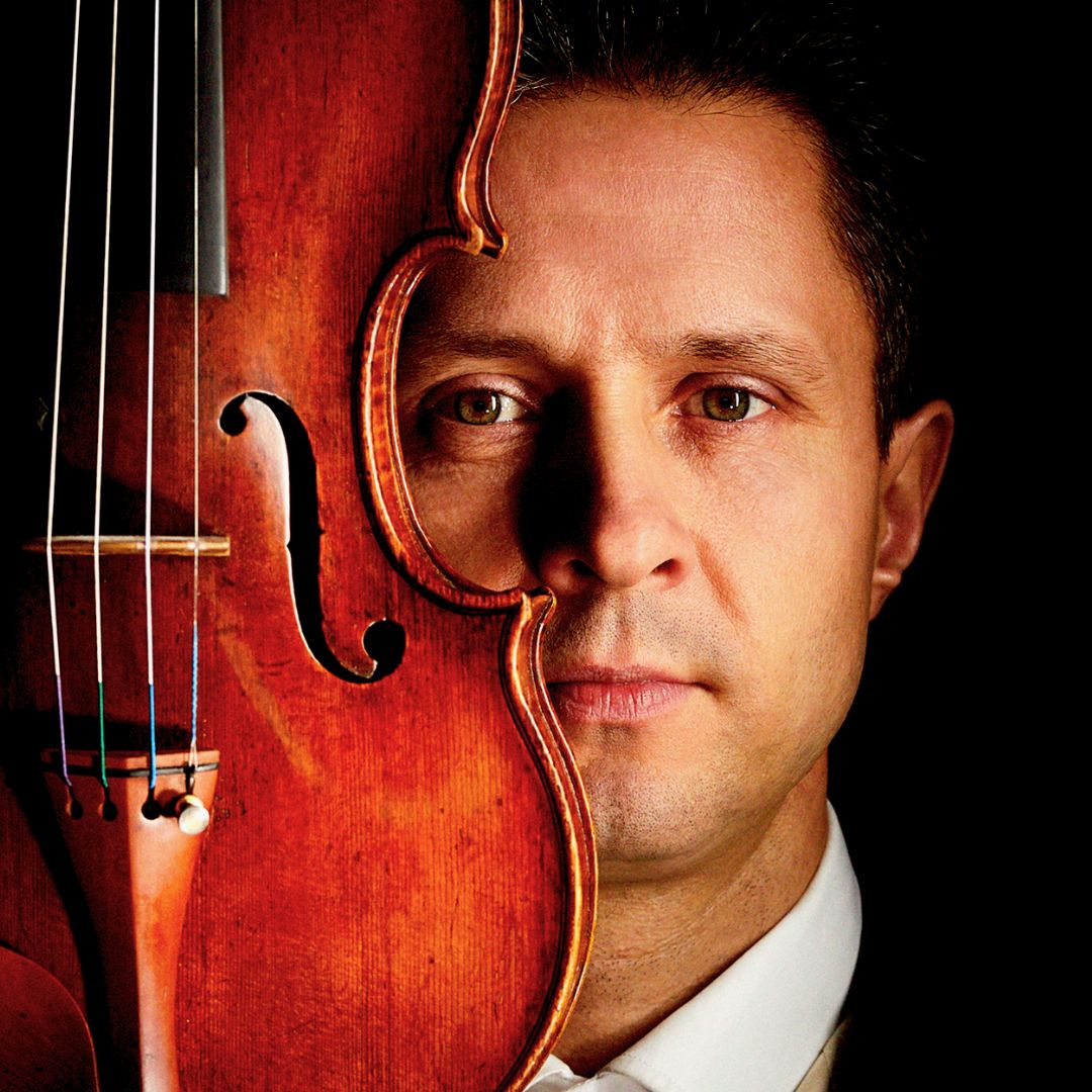 Emmanuel Vukovich holding a violin. 