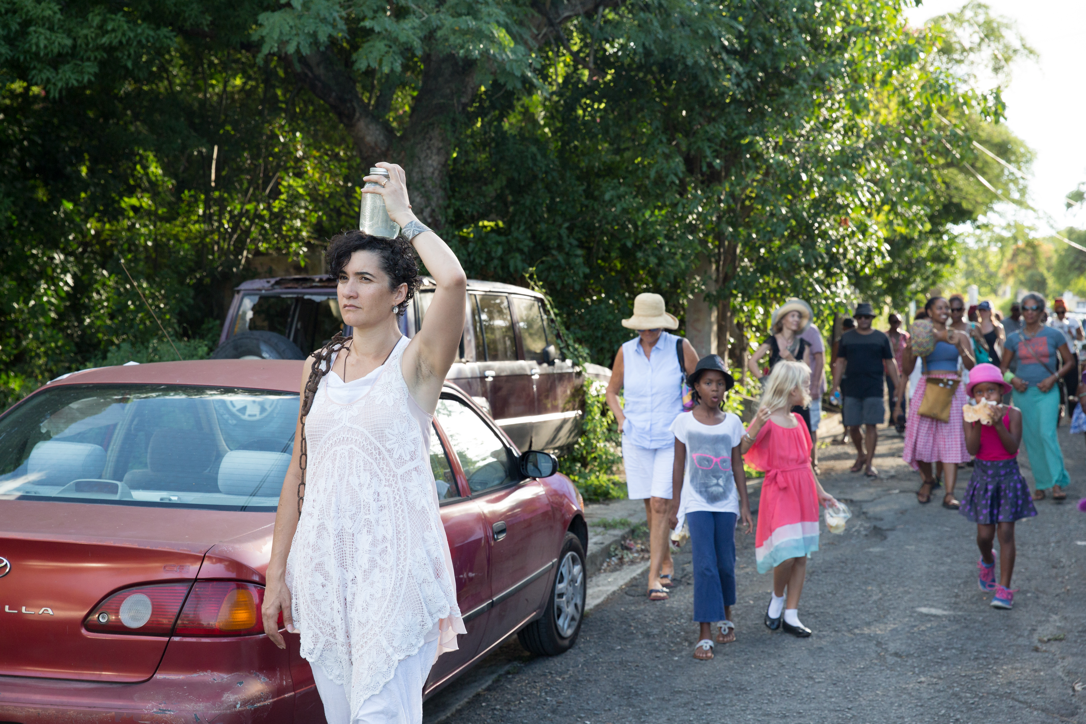 Paloma McGregor and witness-participants walk through Paloma's hometown of Christiansted, St. Croix during a Building a Better Fishtrap performance ritual.