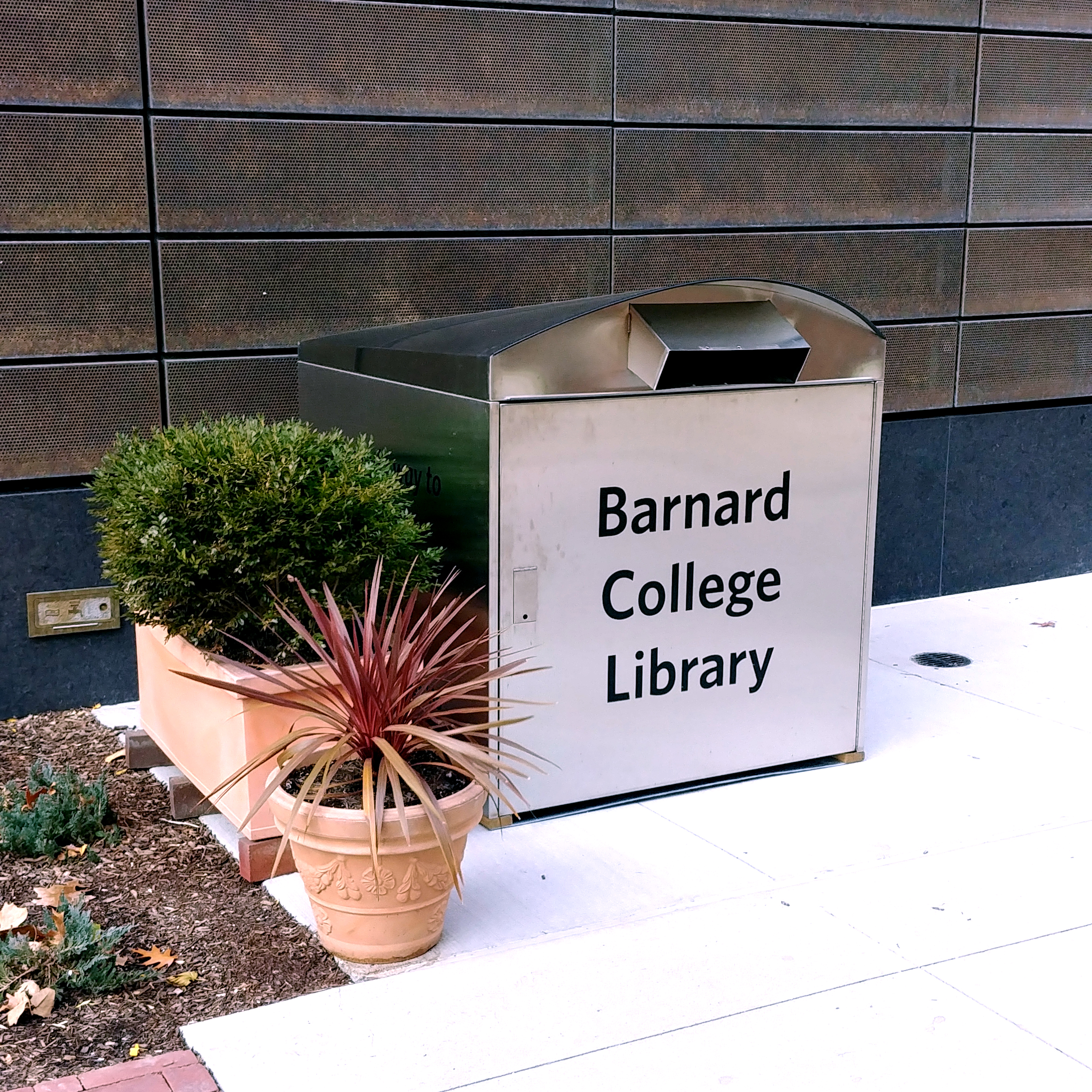The book drop is silver and has "Barnard College Library" written on its front. 