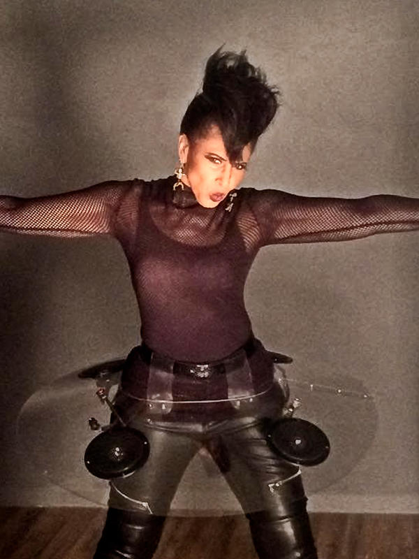 Nona Hendryx striking a pose with her arms out in a black outfit and her "audio tutu".