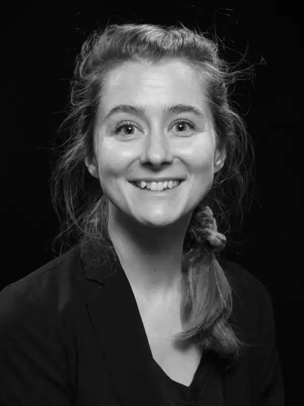 Headshot of Amy LaViers facing the camera and smiling, in black and white