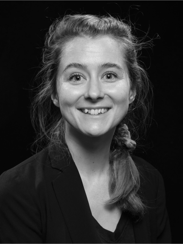 Headshot of Amy LaViers facing the camera and smiling, in black and white